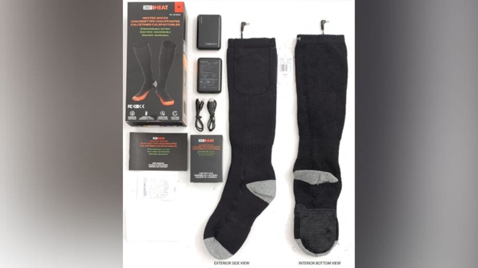 Heated socks against a blurred background with battery pack