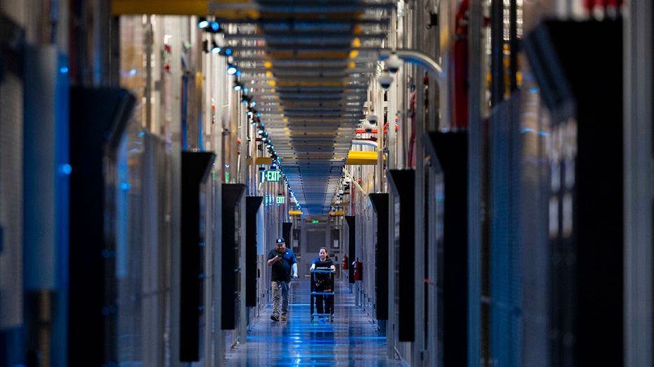 ASHBURN, VA - MAY 9: People walk through the hallways at Equinix Data Center in Ashburn, Virginia, on May 9, 2024. (Amanda Andrade-Rhoades for The Washington Post via Getty Images)