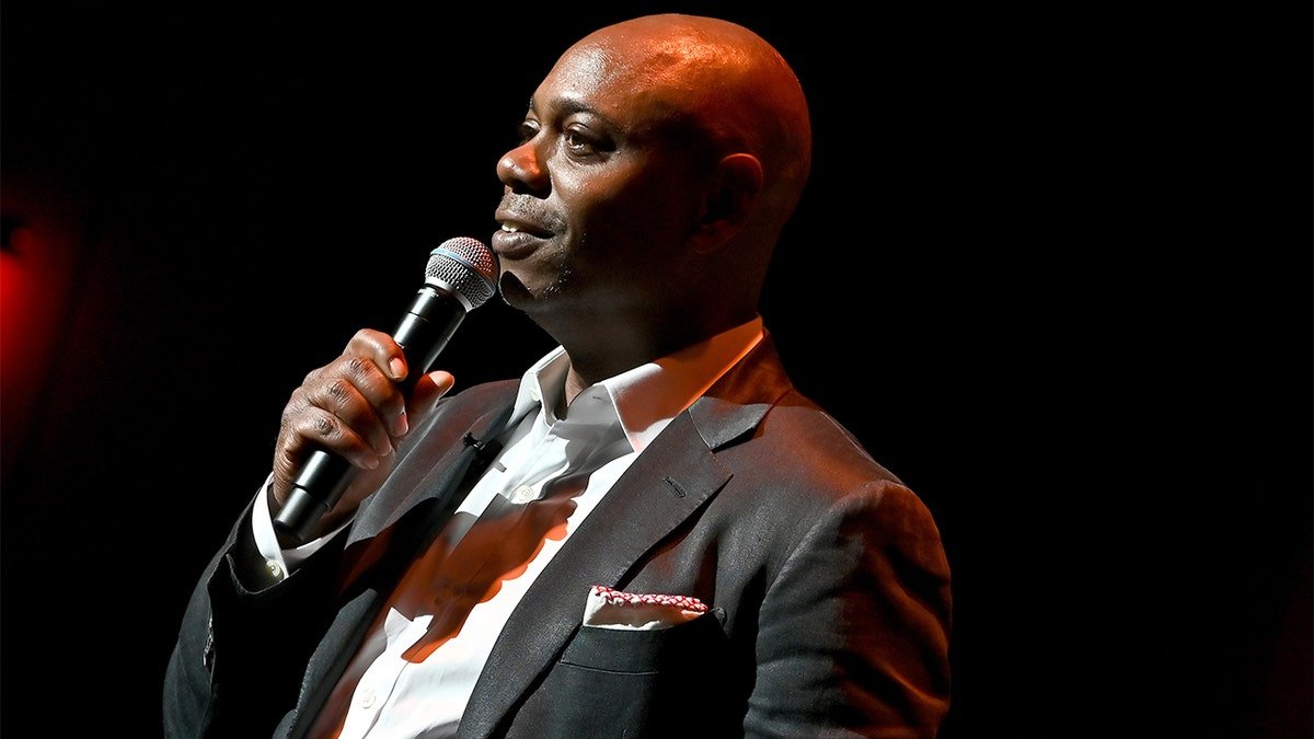 Dave Chappelle performing onstage at Duke Ellington School of the Arts