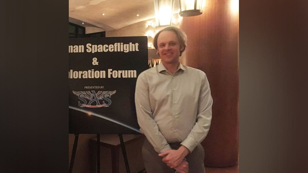 David Wilcock speaking in front of a dark background