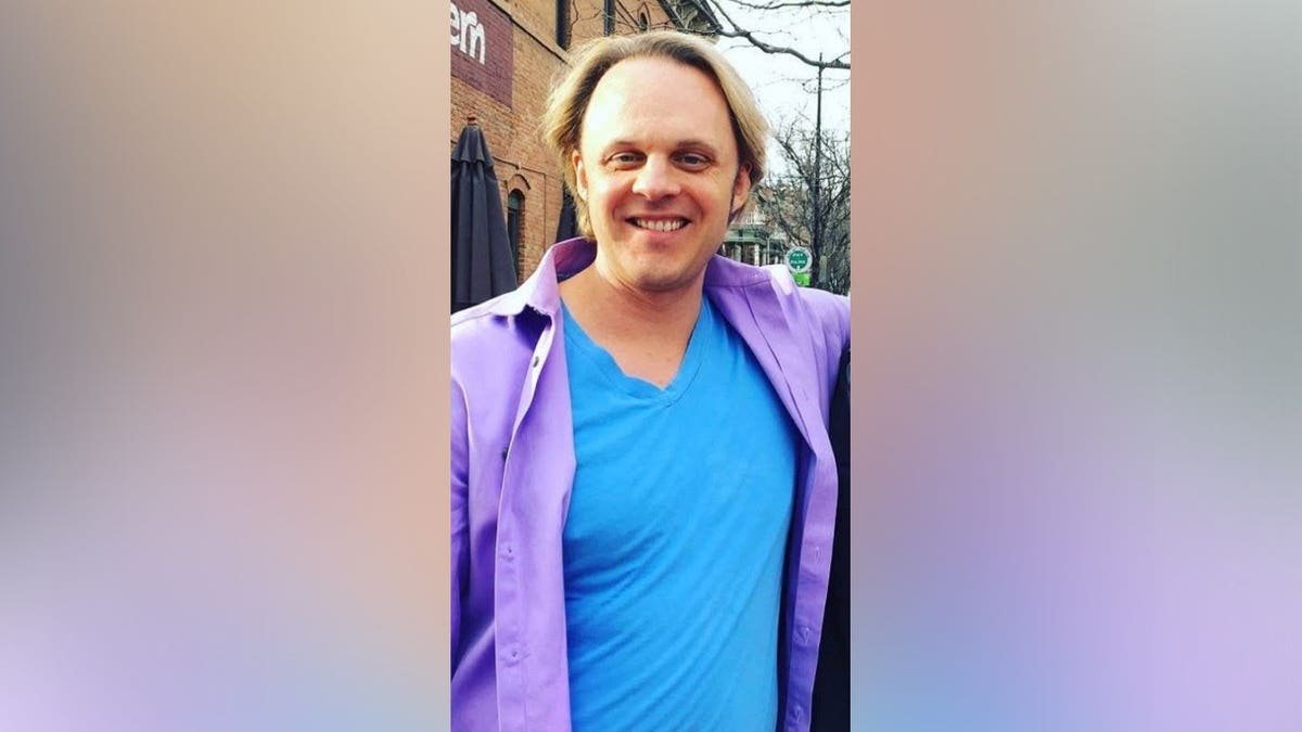 David Wilcock in front of a dark background