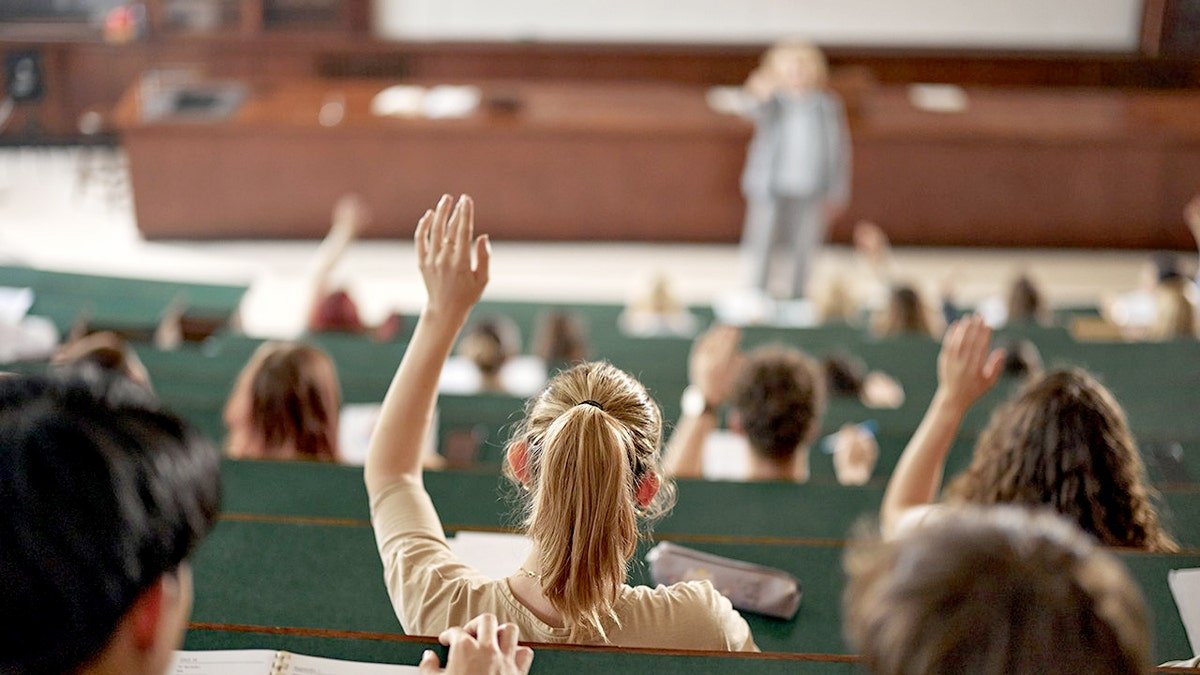 A girl raising her hand in a classroom