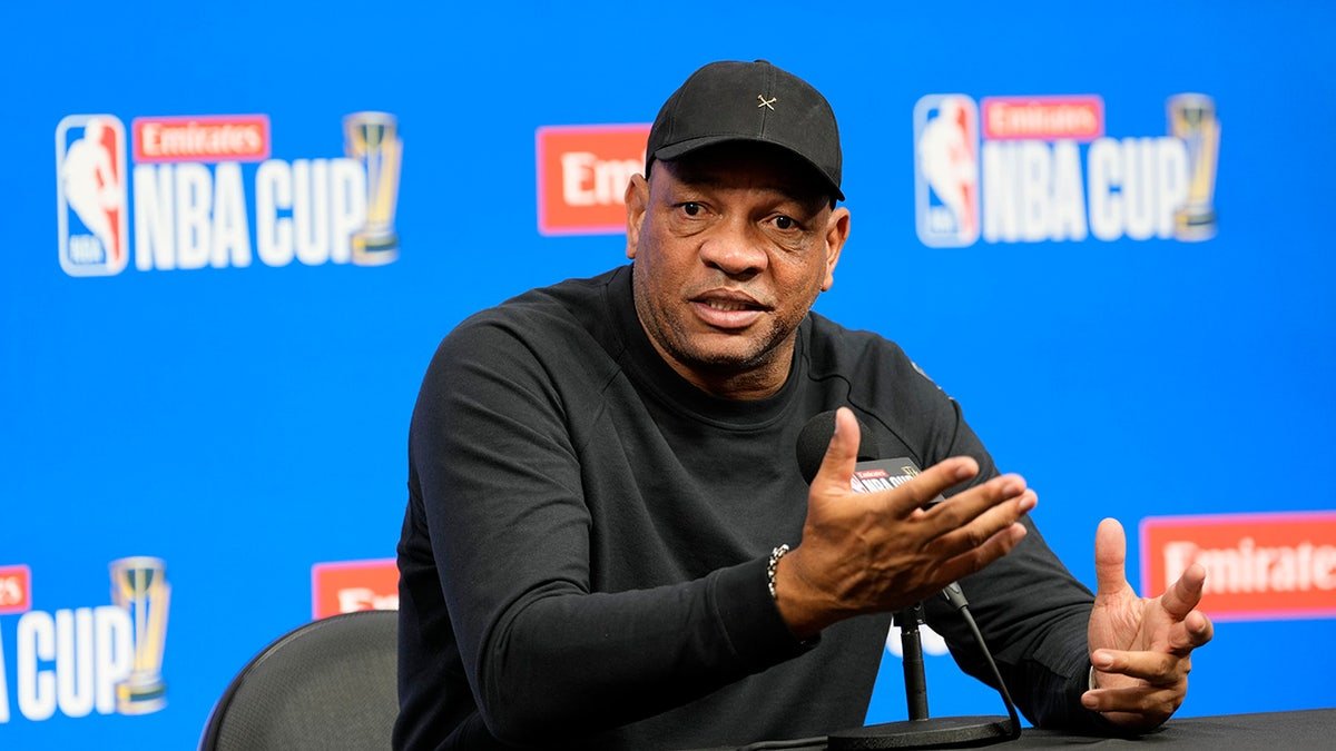 Milwaukee Bucks head coach Doc Rivers speaking at a press conference desk