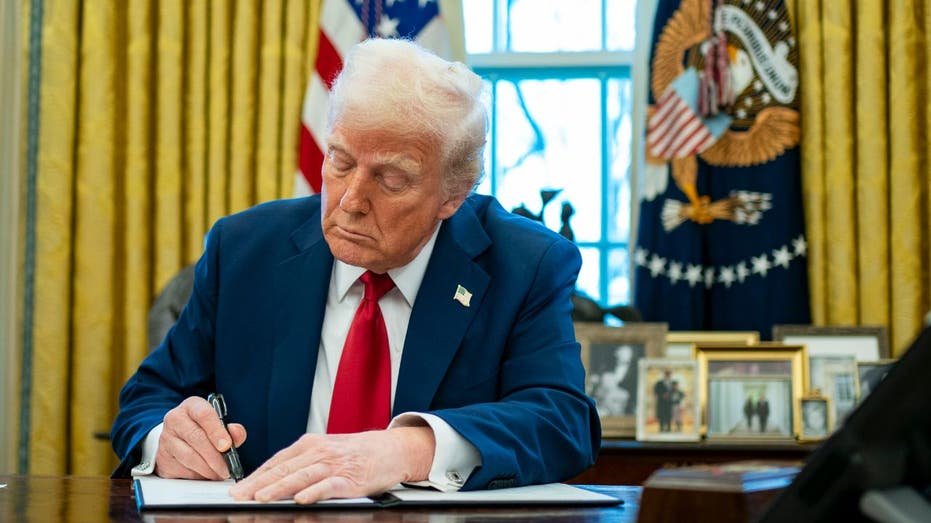 US President Donald Trump signs an executive order