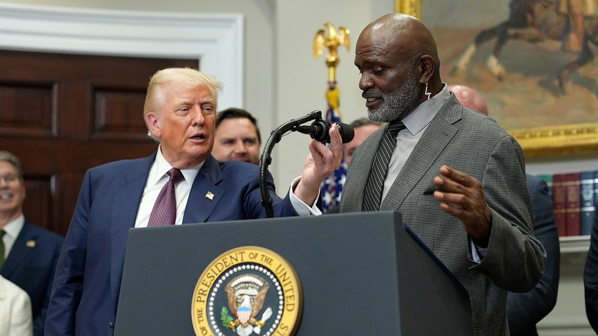President Donald Trump and Lawrence Taylor standing in the Roosevelt Room of the White House