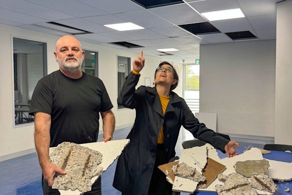 School Council president Geoff Rundell and Greens MP Gabrielle de Vietri with chunks of roof that fell through the classroom ceiling at Collingwood College.