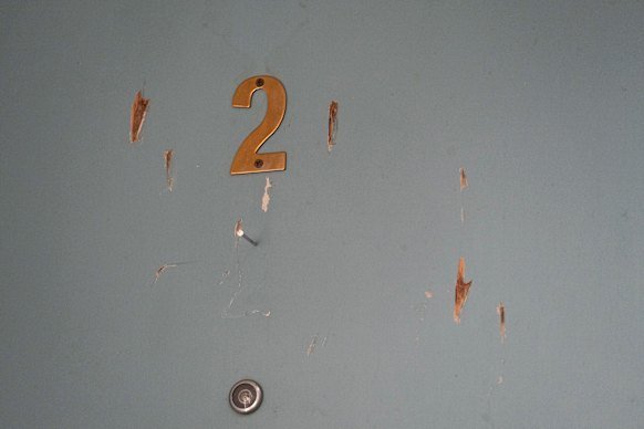 The door to a neighbour’s unit which locals say Graham damaged in 2022.