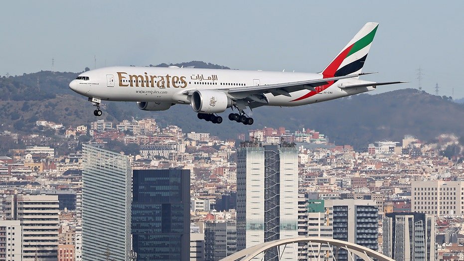 Emirates Boeing 777-21H(LR) flies over Barcelona