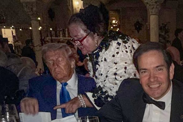 Gina Rinehart talks to US President Donald Trump during a Halloween party at Mar-a-Lago, as Secretary of State Marco Rubio poses in the foreground.