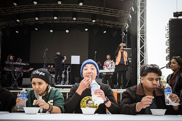 Taste test: Adhish Rai, centre, in blue beanie, competes in the momo speed eating competition at Momo Fest.
