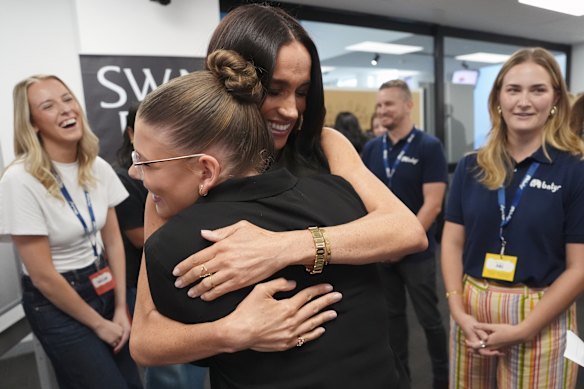 Meghan, pictured here at Swinburne University in Melbourne on Thursday, has had just as much of a warm reception in Australia as her husband.