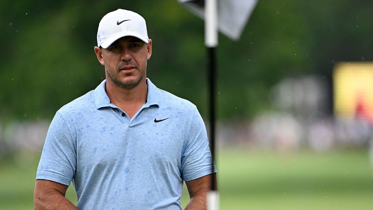 Brooks Koepka walks the 11th hole