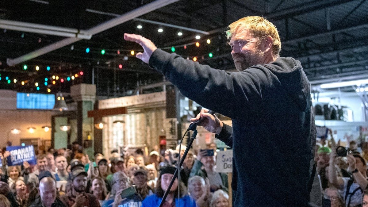 Graham Platner acknowledging a crowd during a town hall in Portland, Maine