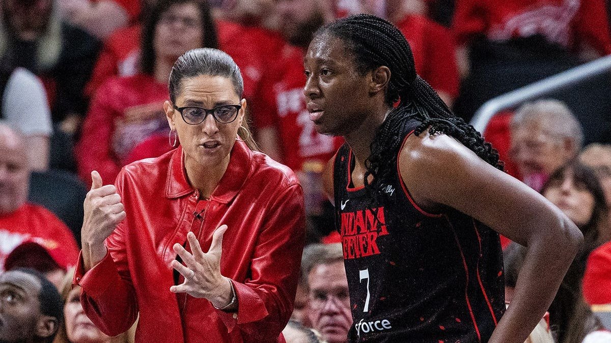 Indiana Fever head coach Stephanie White and forward Aliyah Boston playing basketball at Gainbridge Fieldhouse