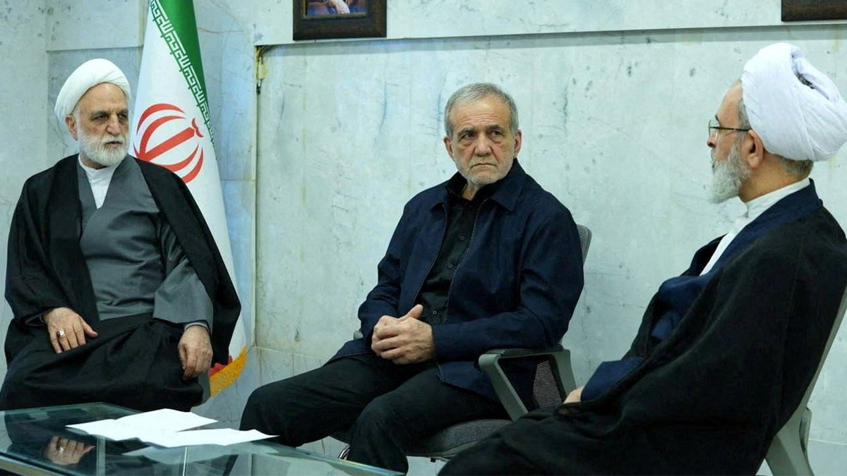 Iranian President Masoud Pezeshkian and judiciary head Gholam-Hossein Mohseni-Eje'i seated at a meeting