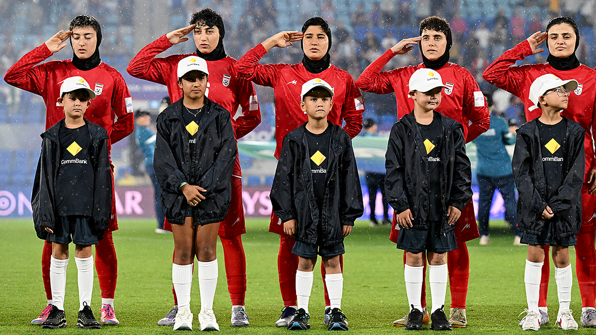 Iran women's soccer players standing during national anthem before match in Robina