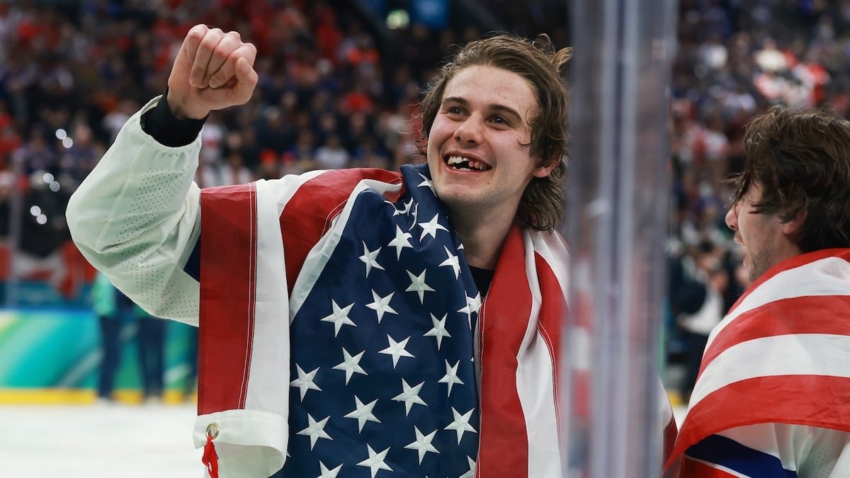 Jack Hughes celebrating after gold-medal win at Milano Santagiulia Ice Hockey Arena