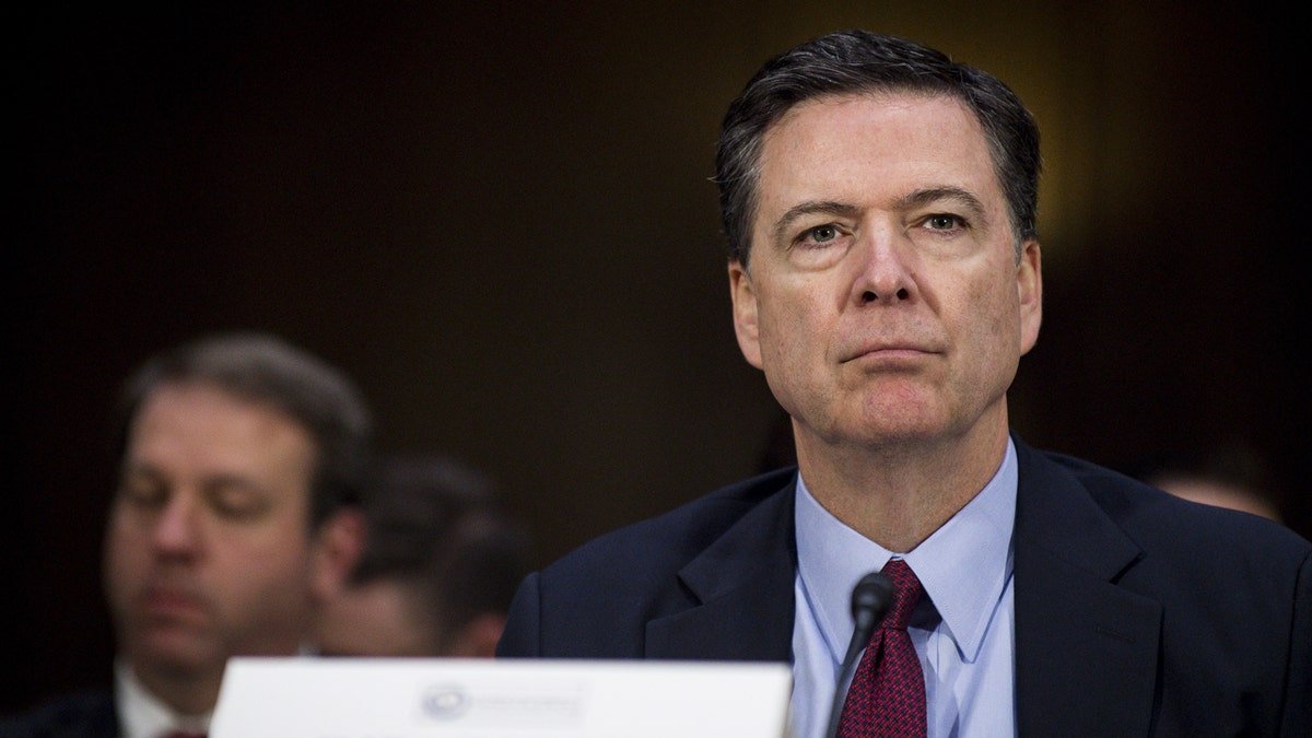 James Comey listening during Senate Intelligence Committee hearing in Washington D.C.