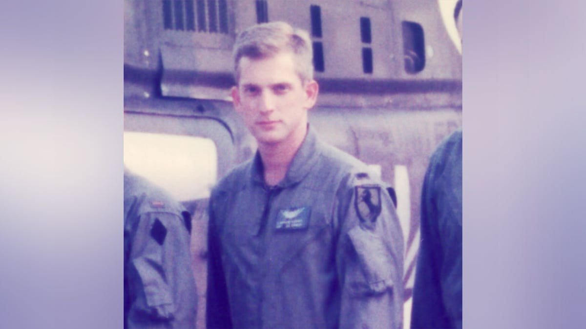James Tony Moffatt standing and smiling in a portrait photo