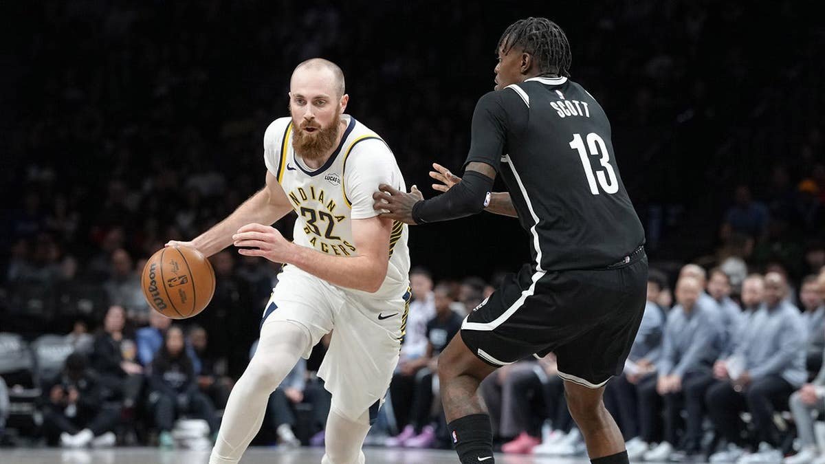 Indiana Pacers center Jay Huff dribbling basketball against Brooklyn Nets forward Trevon Scott at Barclays Center