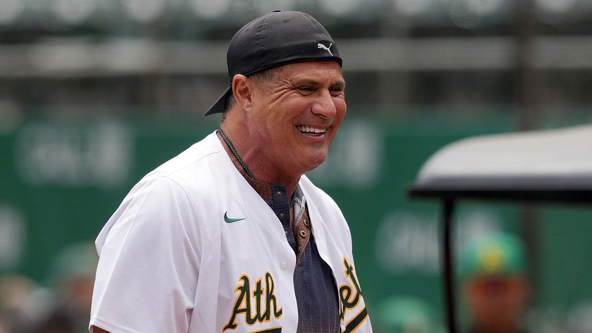 Jose Canseco standing on the field at Oakland-Alameda County Coliseum.
