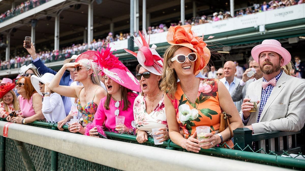 Attendees wearing colorful hats at Kentucky Derby preview day at Churchill Downs in Louisville