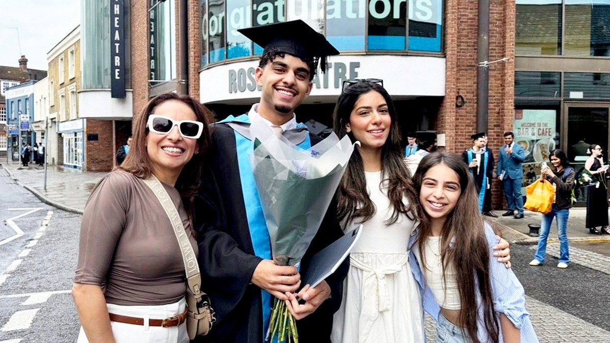 Khaled Sharif and his family smiling at Khaled's graduation.
