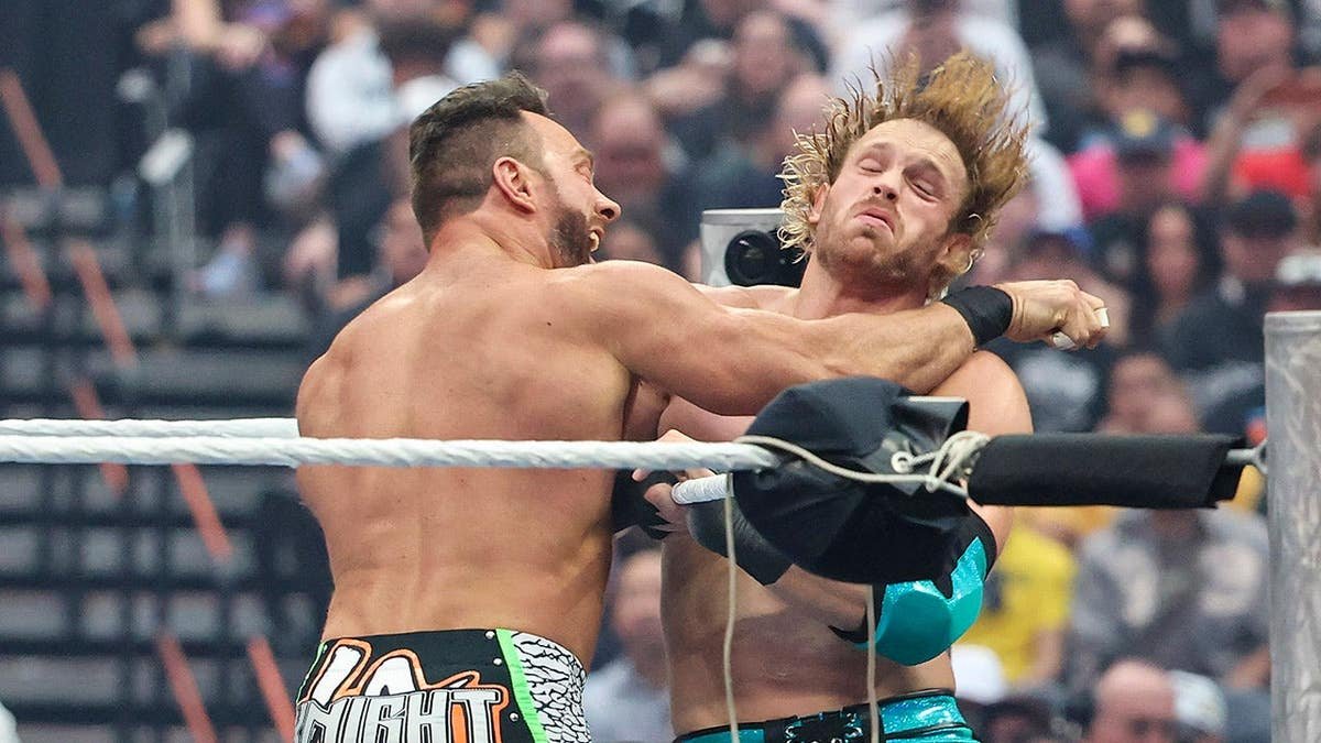 LA Knight landing a punch against Logan Paul in a wrestling match at Allegiant Stadium