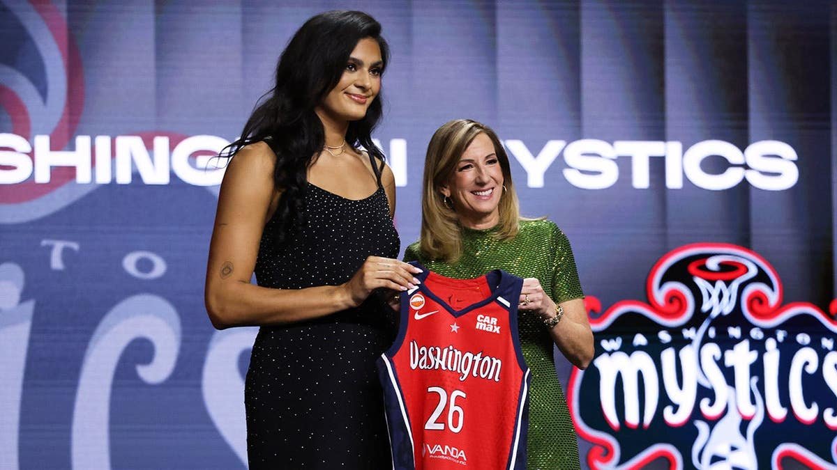 UCLA center Lauren Betts posing with WNBA commissioner Cathy Engelbert