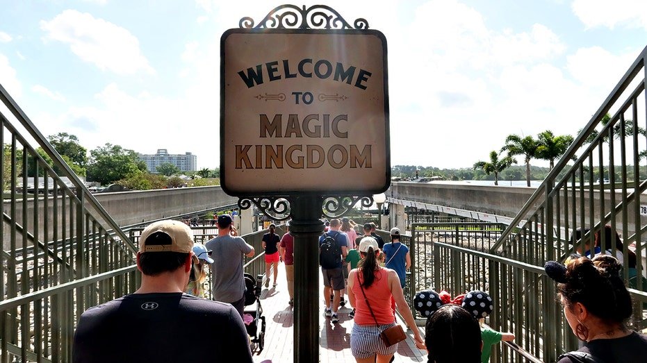 People depart the monorail station at Magic Kingdom