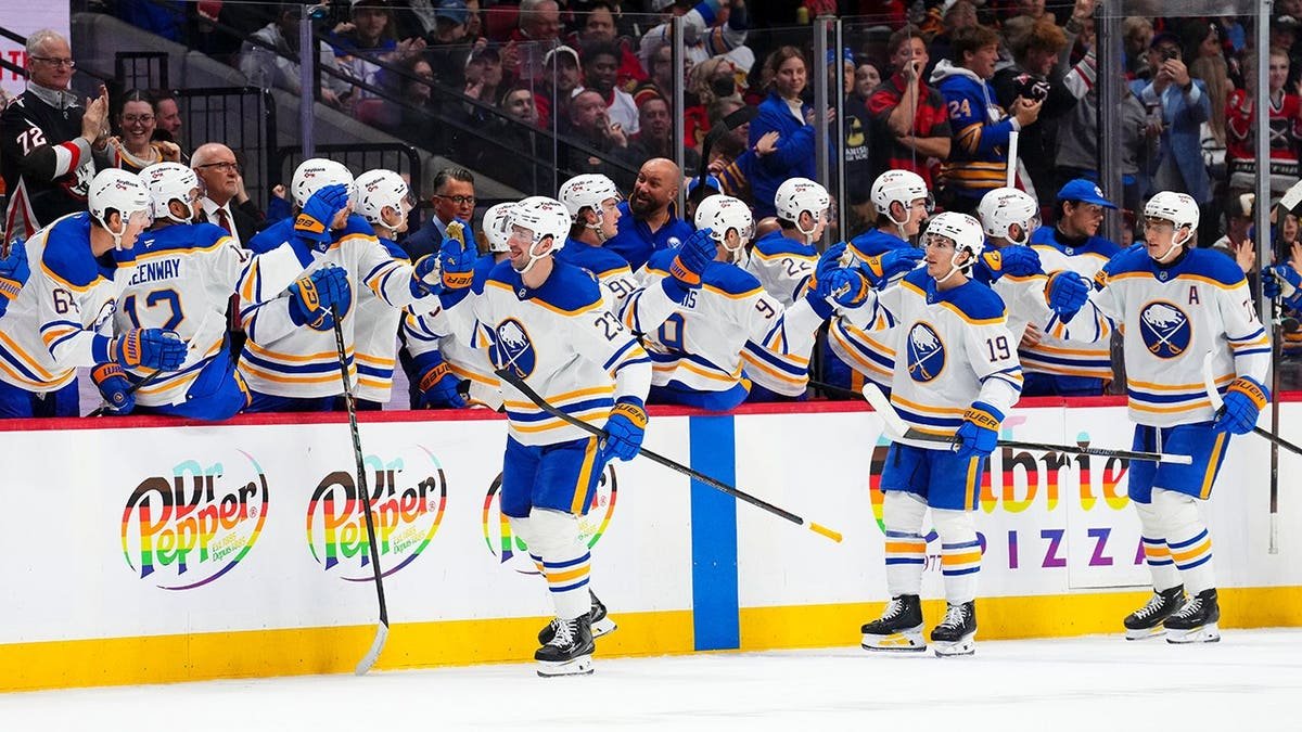 Buffalo Sabres' Mattias Samuelsson celebrating a goal with teammates on the bench during a hockey game in Ottawa