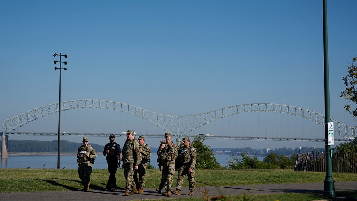 Members of the 117th Military Police Battalion and a Memphis police officer patrolling Tom Lee Park in Memphis