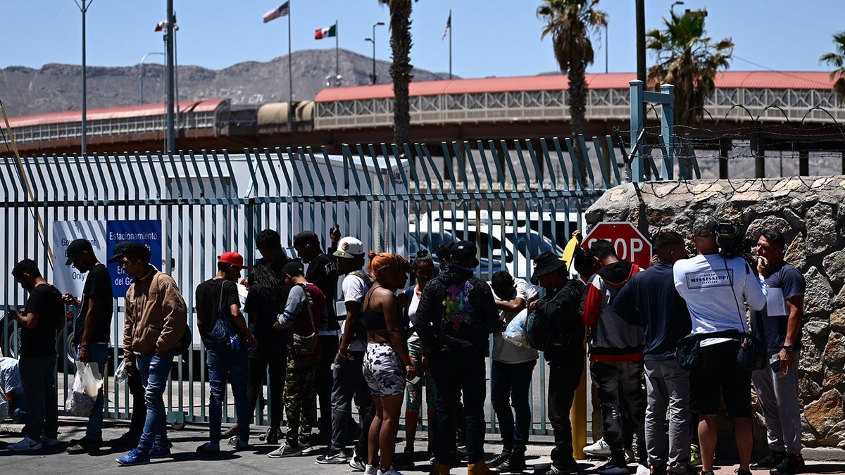 Migrants waiting in line to turn themselves in near the Paso del Norte Port of Entry in El Paso, Texas
