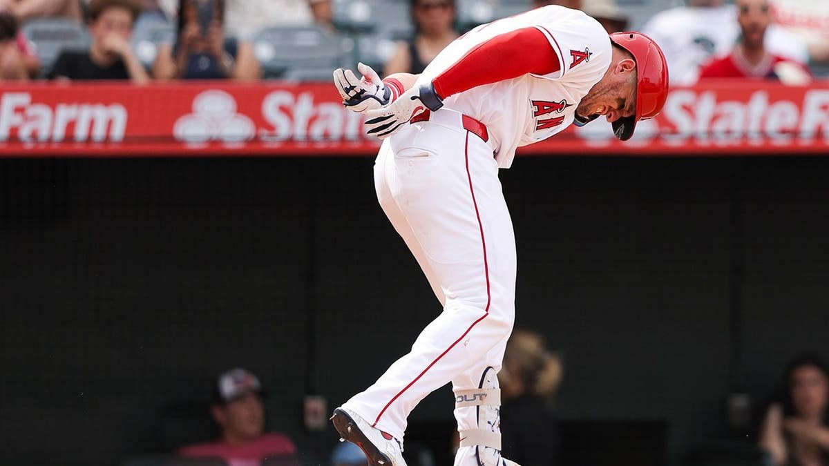 Los Angeles Angels' Mike Trout reacting after being hit by a pitch during a baseball game.