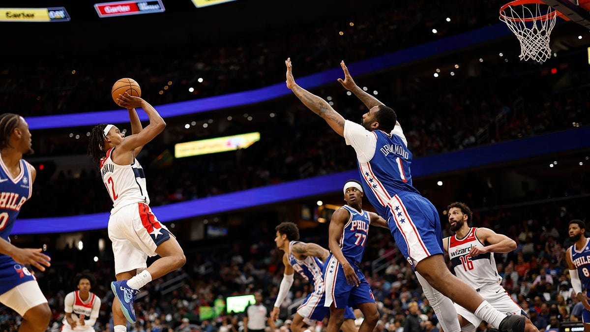 Washington Wizards guard Tre Johnson shooting over Philadelphia 76ers center Andre Drummond at Capital One Arena