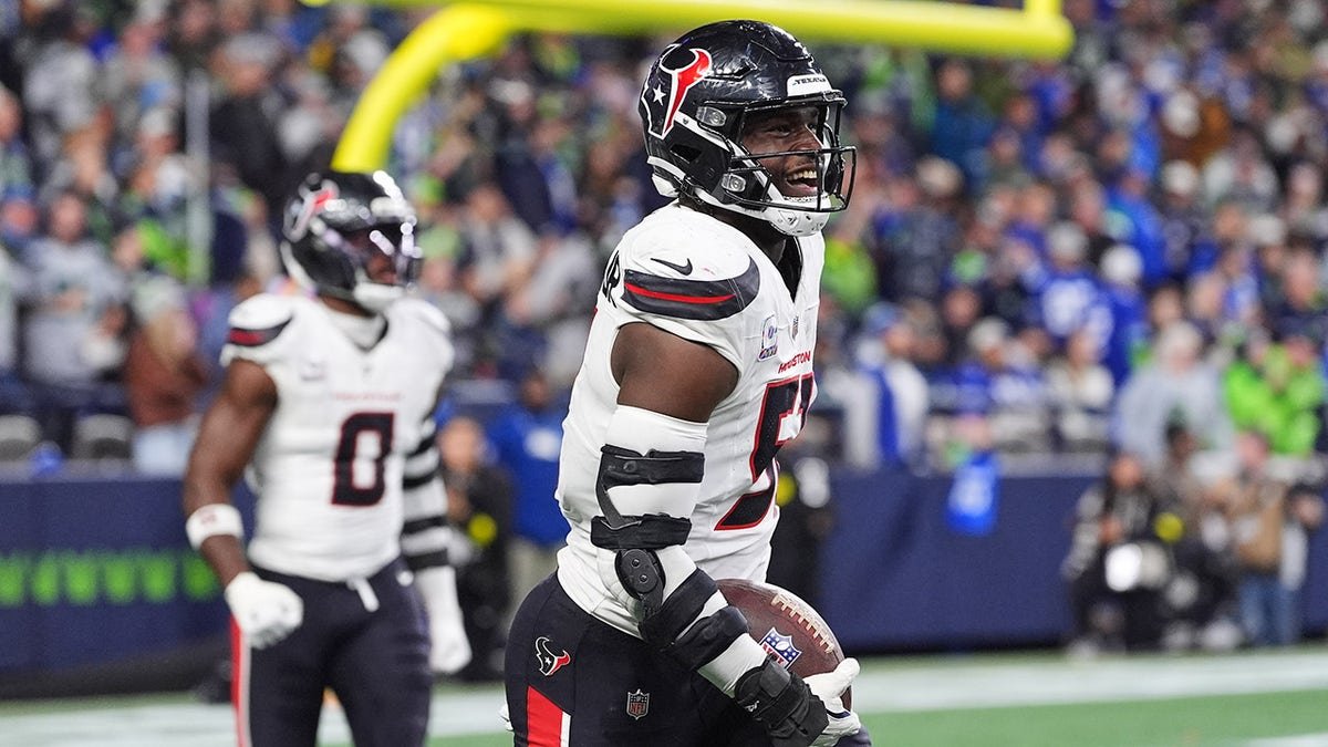 Houston Texans defensive end Will Anderson Jr. celebrating a touchdown on the field.