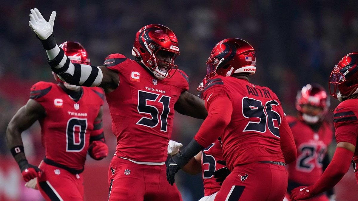 Will Anderson Jr. and Denico Autry celebrating a sack during an NFL game in Houston