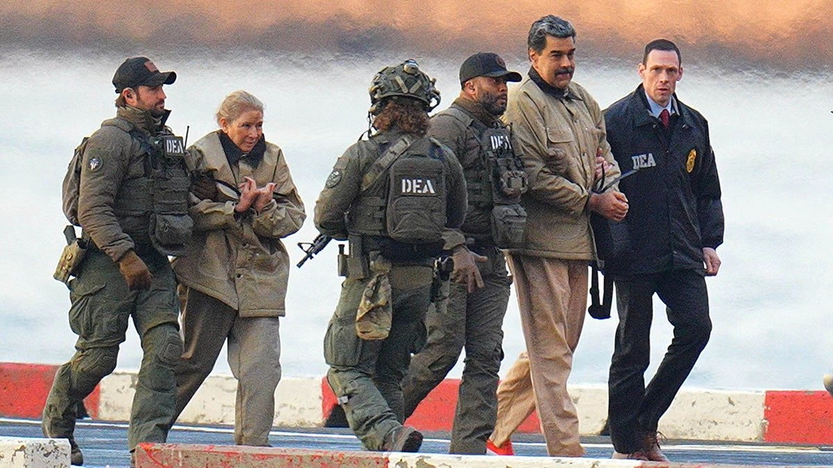 Nicolas Maduro and wife Cilia Flores in handcuffs escorted by federal agents at Manhattan helipad