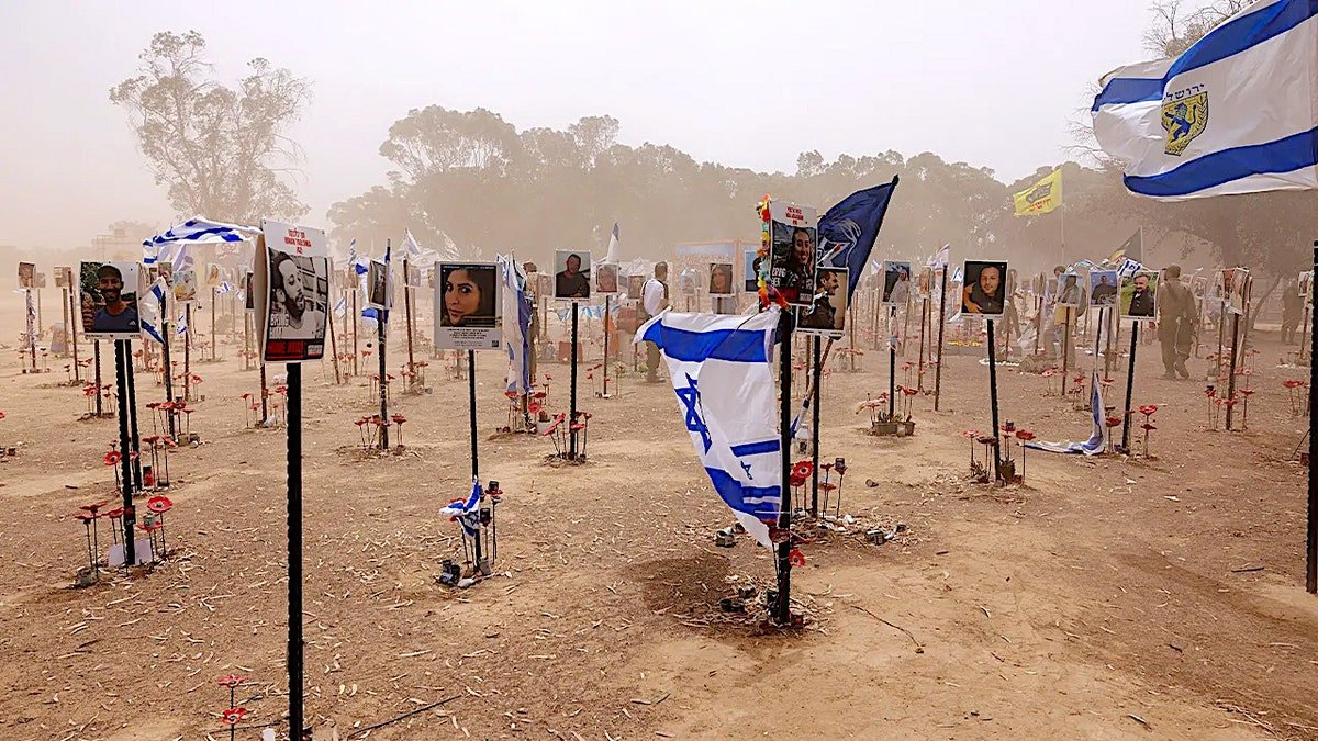 Israeli flag fluttering at memorial site for victims of Hamas terror attack near Kibbutz Re'im