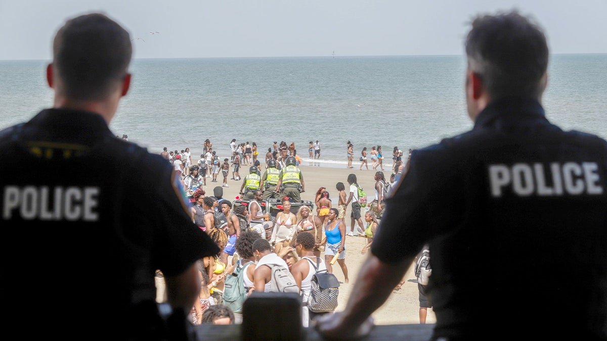 Police watch during the Orange Crush festival in Tybee Island, Georgia