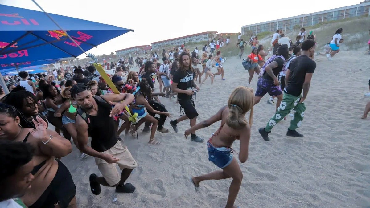 Festival goers run from the stage after someone yelled that a gun was seen on Saturday, April 19, 2025 during Orange Crush on Tybee Island.