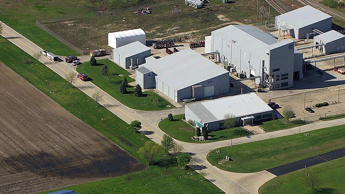An overhead shot of a large industrial complex with several silver metal buildings