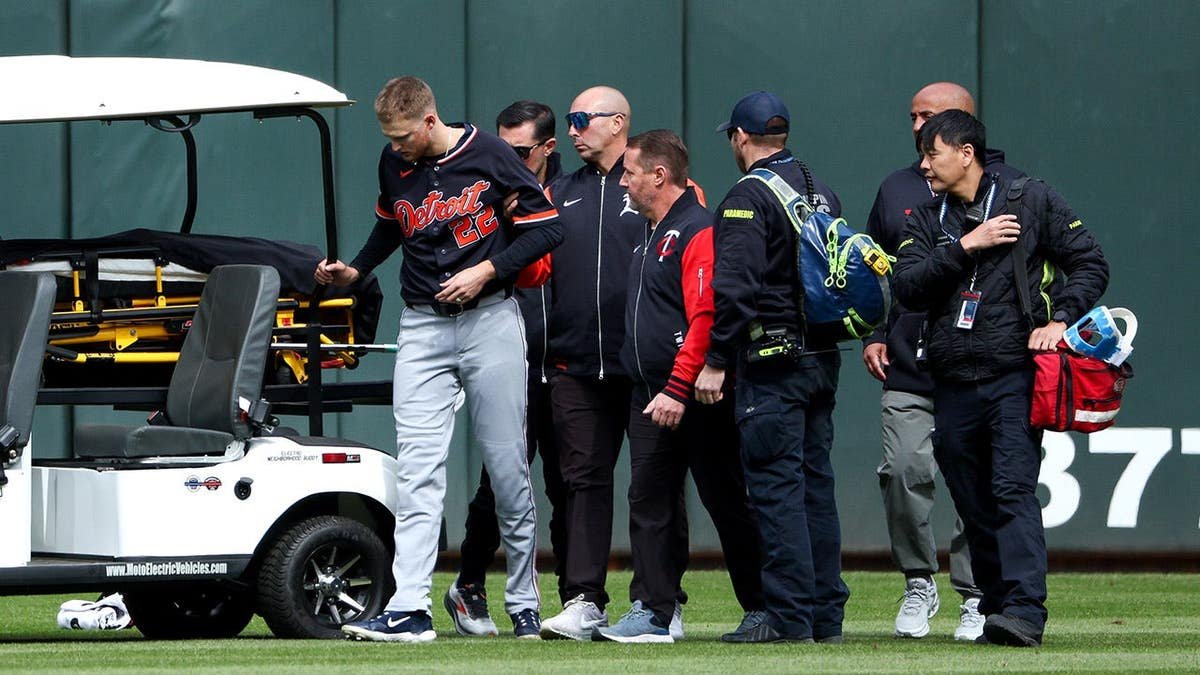 Detroit Tigers center fielder Parker Meadows being helped off the field after collision