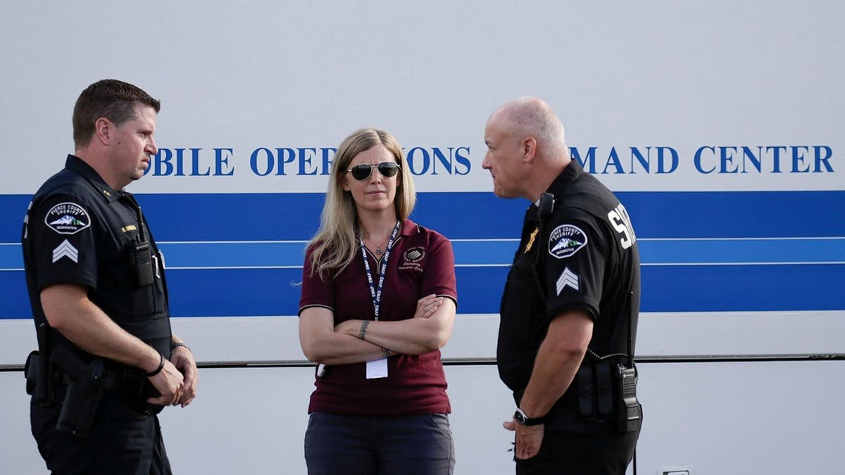 Members of the Pierce County Sheriffs Department standing near Steilacoom Ferry dock