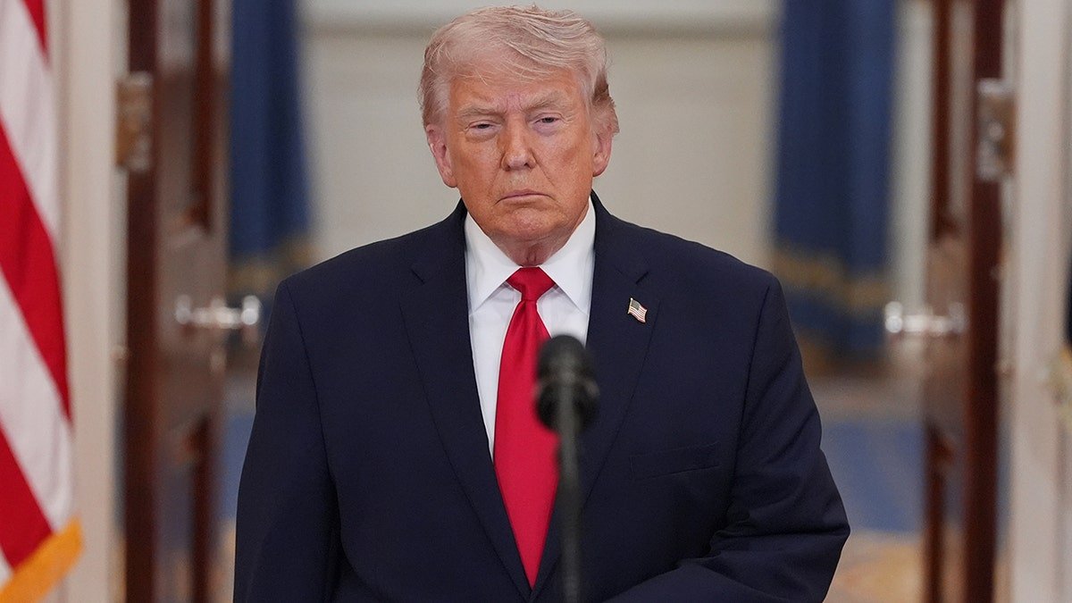 President Donald Trump standing in the White House Cross Hall speaking