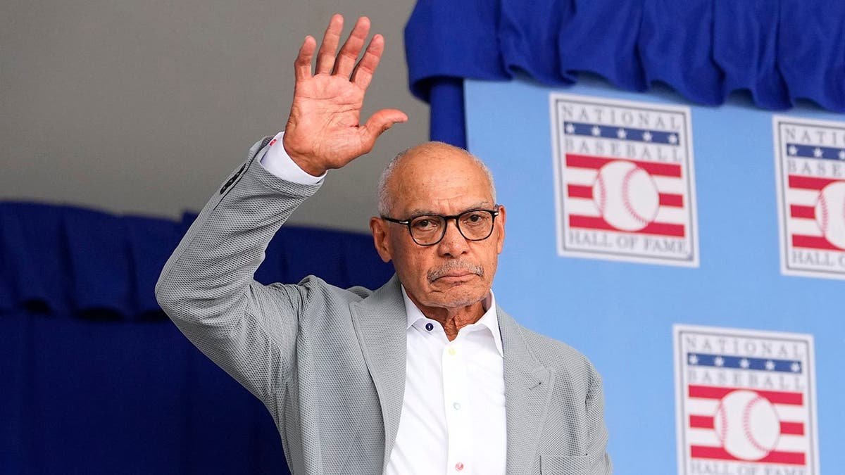 Hall of Famer Reggie Jackson standing at a podium during an induction ceremony