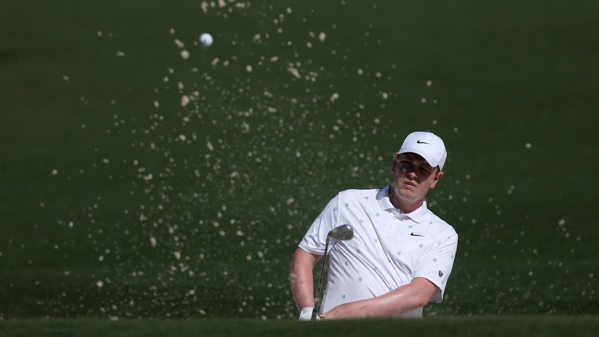 Robert MacIntyre playing a shot from a bunker on the second hole at Augusta National Golf Club