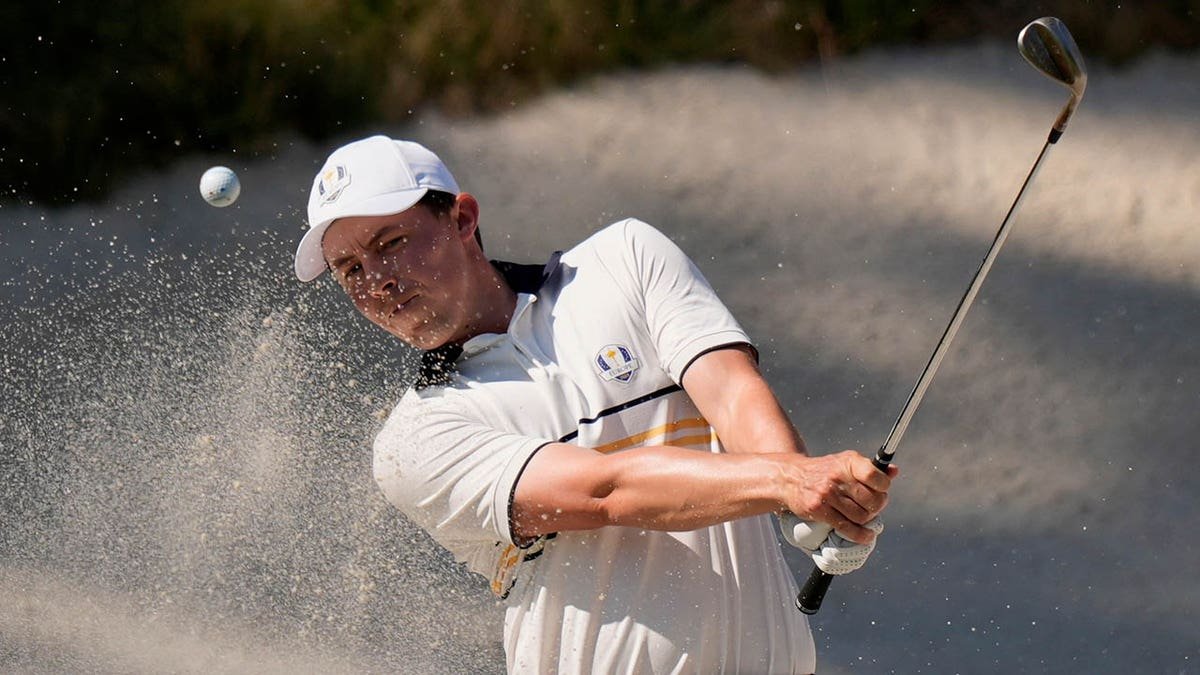 Matthew Fitzpatrick hitting golf ball from bunker on the eighth hole at Ryder Cup