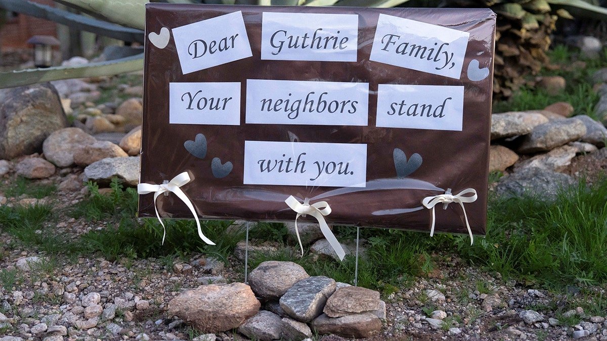 A supportive handwritten sign posted outside Nancy Guthrie's home in Tucson