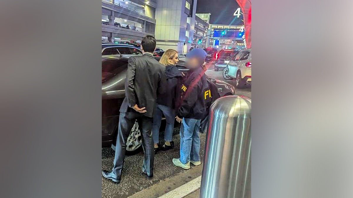 Photo of authorities arresting Shamim Mafi.